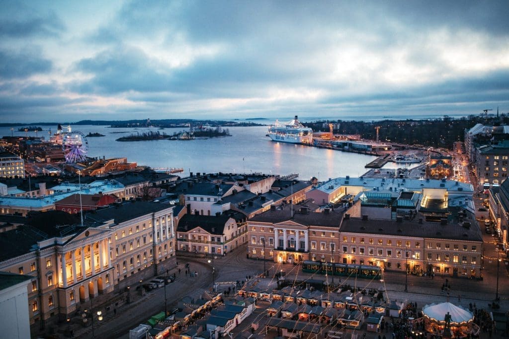 Aerial view from above Helsinki Cathedral, with the Senate Square in the frame, looking out towards Helsinki harbour in the evening.