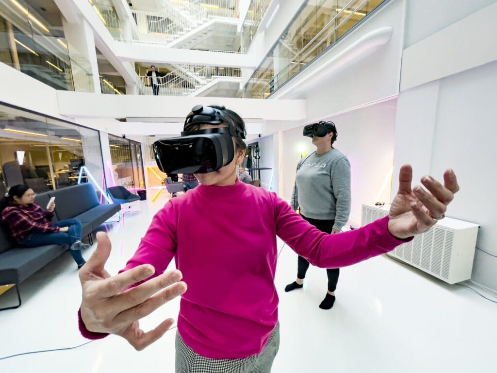 Woman in a pink shirt with VR glasses