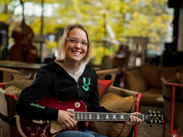 Lauren Bengston playing the guitar outside