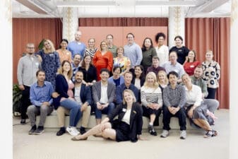 Group photo of the 90 Finn cohort of 2023, their families, and Helsinki Partners staff