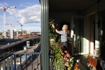 Woman on a balcony in front of construction