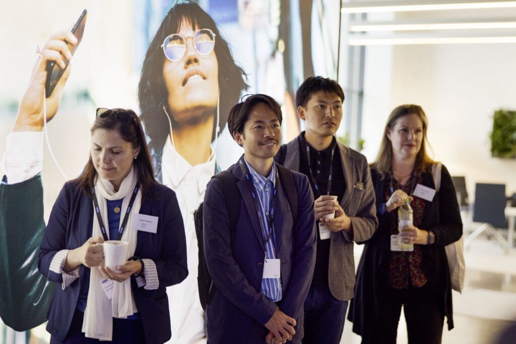 Group of business people listening attentively on a company tour