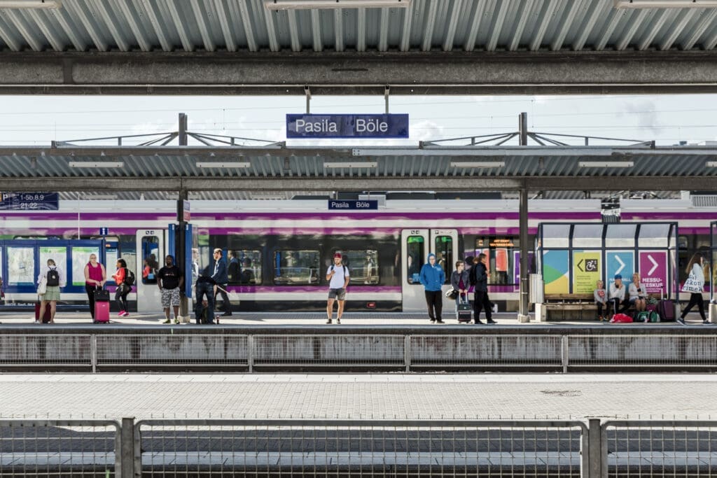 People stand waiting for a train at Pasila railway station