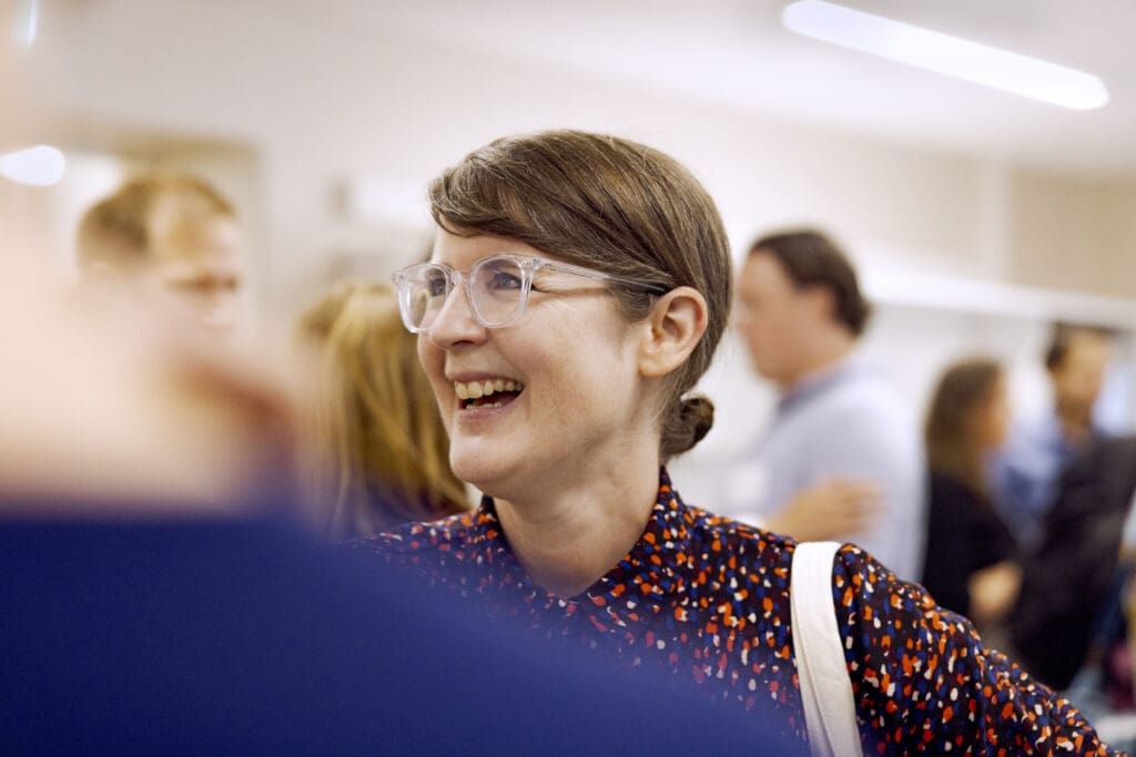 Woman laughing at a networking event