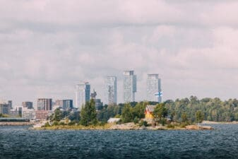 Island with a small house and a Finnish flag in the Helsinki archipelago